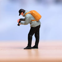 Orange Backpack Bending Male Figurine Light Blue Top Collectible Figure Display Piece for Collectors