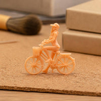 Peach Plastic Girl Bike Figurine Spoked Wheels Girl on Cycle Figure
