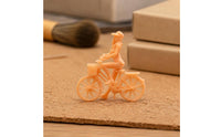 Peach Plastic Girl Bike Figurine Spoked Wheels Girl on Cycle Figure