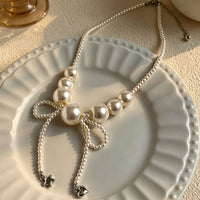 Oversized Faux Pearl Bow Necklace with Tassel